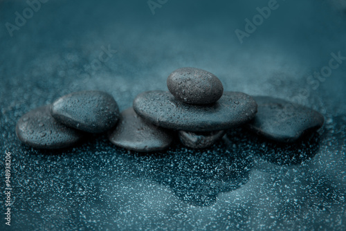 Black spa stones on the gray table background.