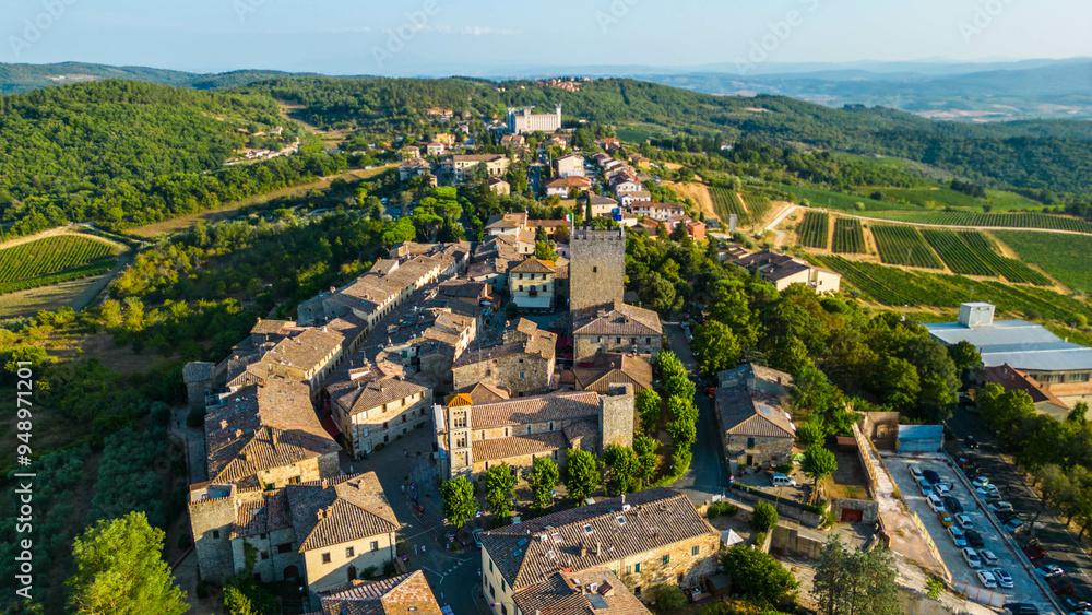 An aerial view of Castellina in Chianti, a picturesque town in Tuscany's renowned Chianti wine region, captured by a drone. Perched on a hill, Castellina in Chianti is surrounded by rolling vineyards An aerial view of Castellina in Chianti, a picturesque town in Tuscany's renowned Chianti wine region, captured by a drone. Perched on a hill, Castellina in Chianti is surrounded by rolling vineyards