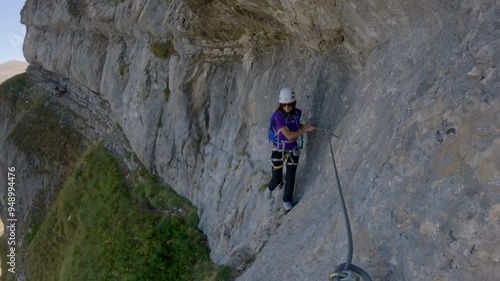 Female Rock Climber Climbing A Rock Wall Via Ferrata