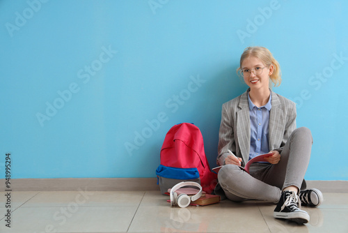 Happy female student with b...