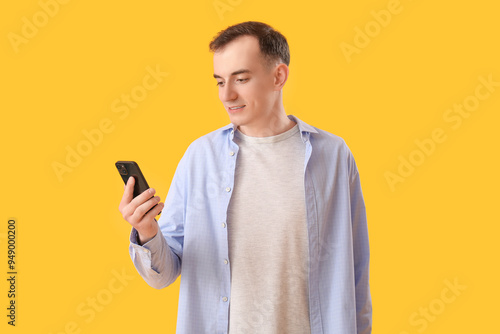 Young man with mobile phone...