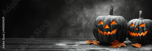 Two glowing black jack-o'-lanterns dominate a modern. Halloween concept, copy space, top view