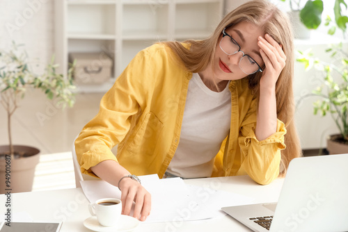 Stressed young businesswoman working under deadline in office