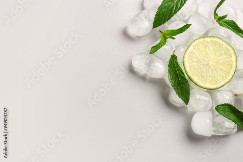 Fototapeta Naklejka Na Ścianę i Meble -  Lime slice with ice cubes and mint on white background
