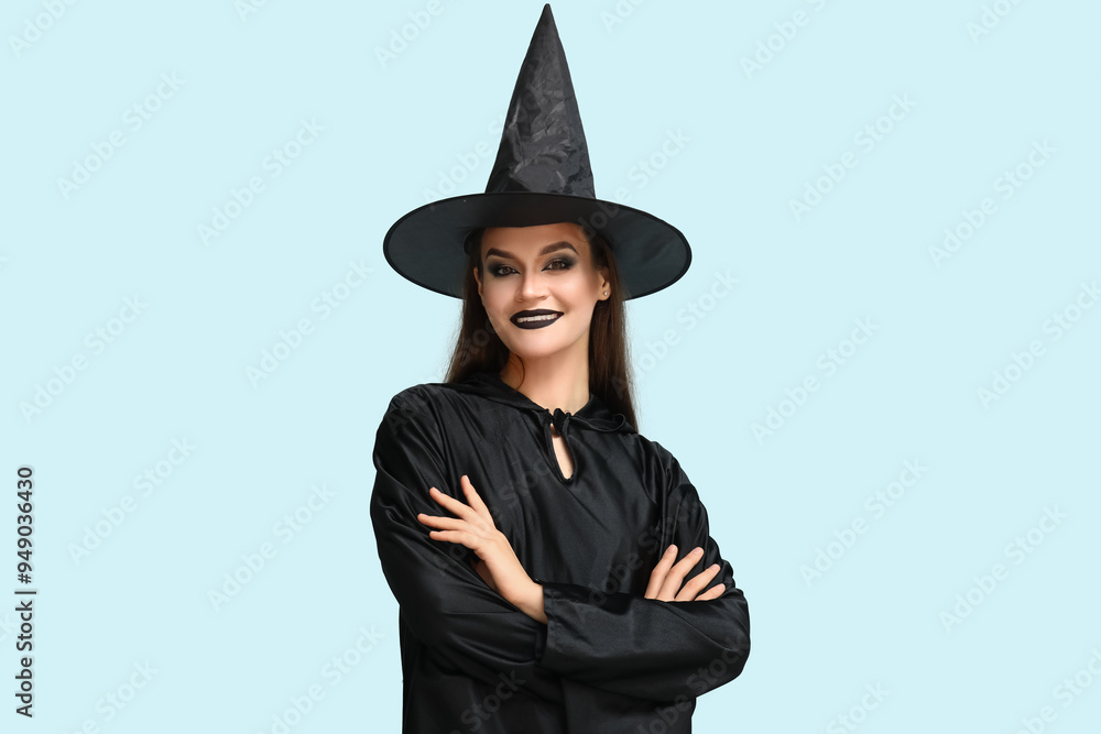 Young woman dressed for Halloween as witch on blue background Young woman dressed for Halloween as witch on blue background