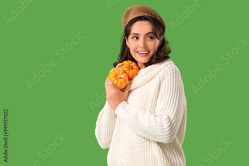 Young woman with pumpkins o...