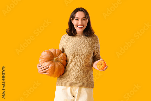 Young woman with pumpkins o...