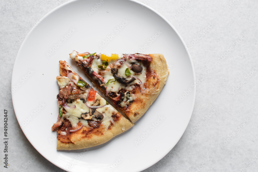 Overhead view of chicken pizza slices on a white plate, top view of beef and mushroom pizza slice Overhead view of chicken pizza slices on a white plate, top view of beef and mushroom pizza slice