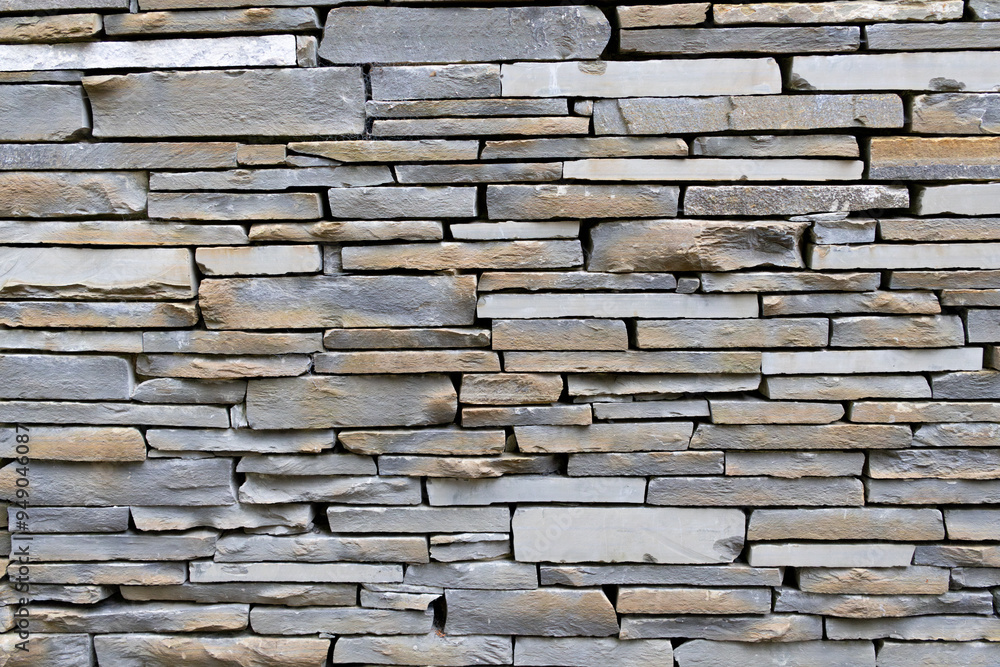 Light brown and grey stone wall with empty space in between. Beautiful stone pattern, background. Wallpaper Light brown and grey stone wall with empty space in between. Beautiful stone pattern, background. Wallpaper