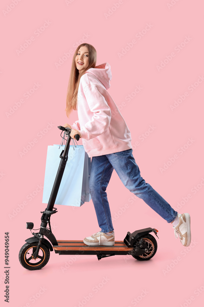 Young pregnant woman with electric kick scooter and shopping bags on pink background Young pregnant woman with electric kick scooter and shopping bags on pink background
