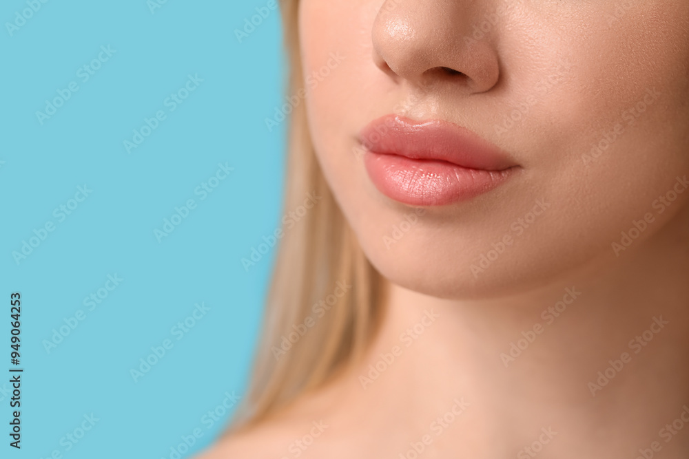 Young woman with beautiful lips on blue background, closeup Young woman with beautiful lips on blue background, closeup