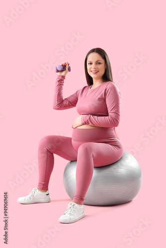 Pregnant woman exercising w...