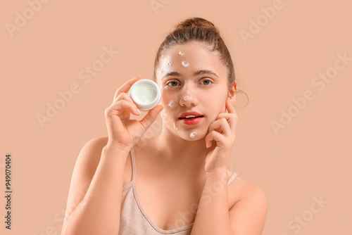 Young woman with jar of fac...