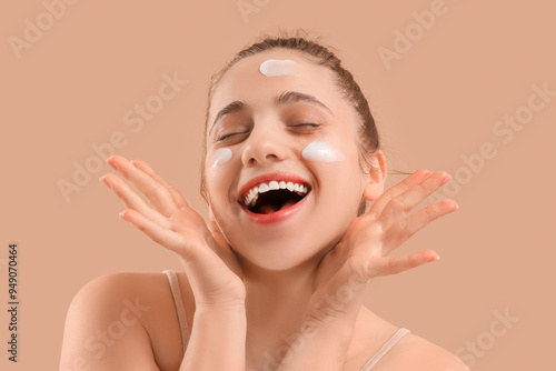 Young woman with facial cre...