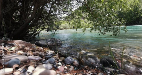 Munzur Stream is a peaceful river view with its clear waters and green tone. It is an ideal option for your nature-themed projects. photo