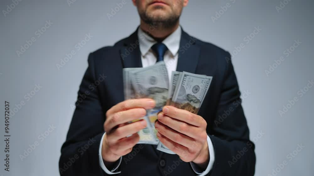 Formally dressed man is counting US Dollar bills, close-up. Formally dressed man is counting US Dollar bills, close-up.