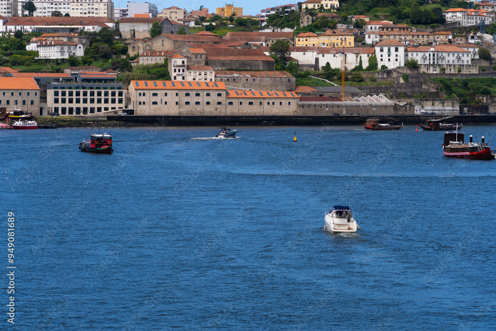 Obraz premium View of Porto city and Douro river and Dom Luis bridge. Porto, Vila Nova de Gaia, Portugal. Cityscape along the river
