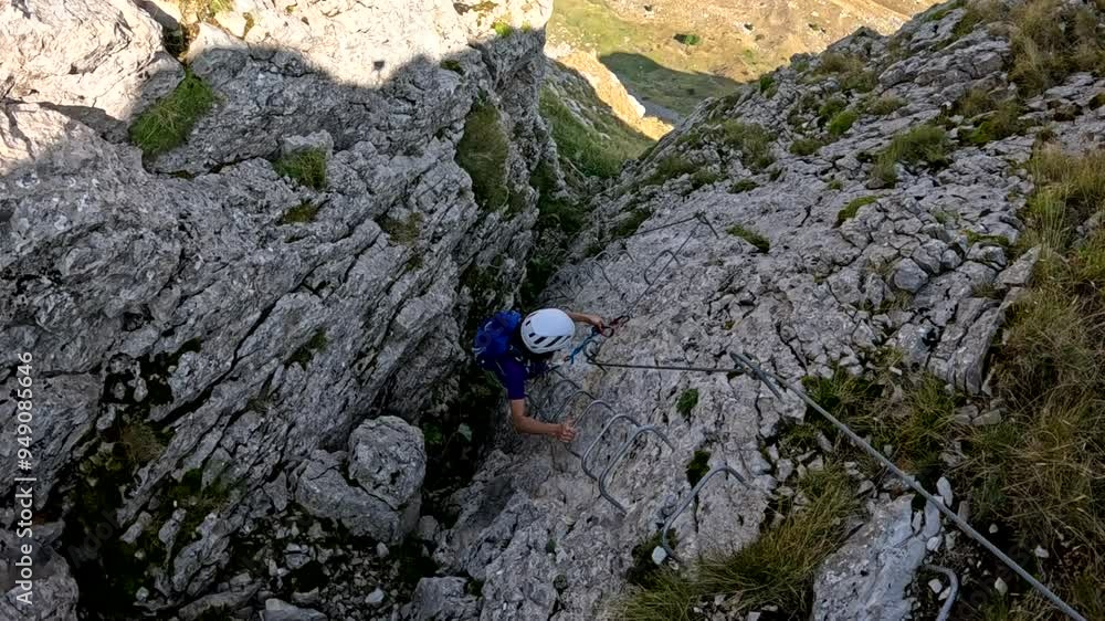 Female Rock Climber Climbing A Rock Wall Via Ferrata Female Rock Climber Climbing A Rock Wall Via Ferrata