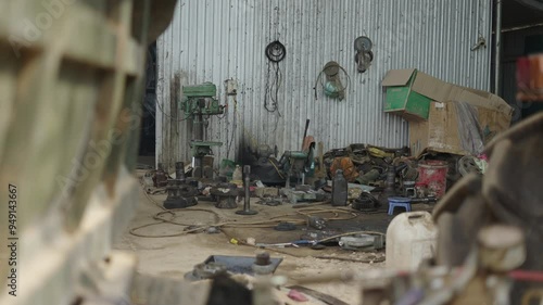 small dirty and messy humble family mechanic workshop in a rural area of vietnam photo