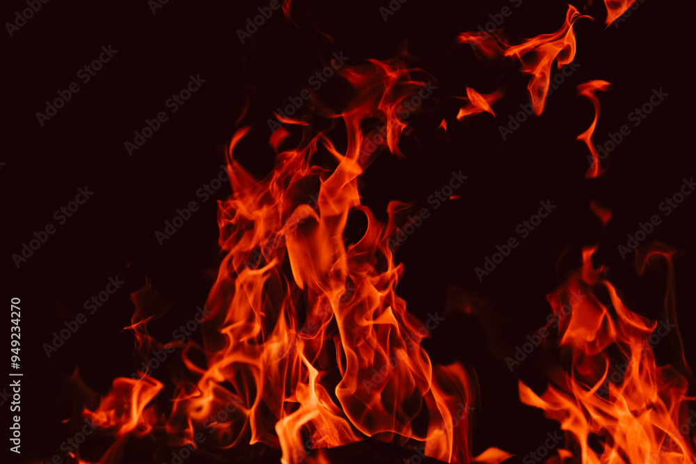 flames and sparks in the dark. Flame background.Red black sparks and flames background. Fire texture on black background.fiery wallpaper.Bonfire close-up. flames and sparks in the dark. Flame background.Red black sparks and flames background. Fire texture on black background.fiery wallpaper.Bonfire close-up.