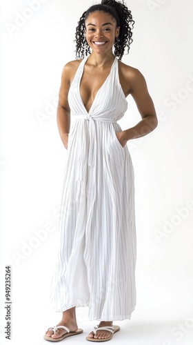 A woman in a sleeveless white maxi dress poses while smiling, exuding a relaxed and fashionable vibe perfect for summer occasions