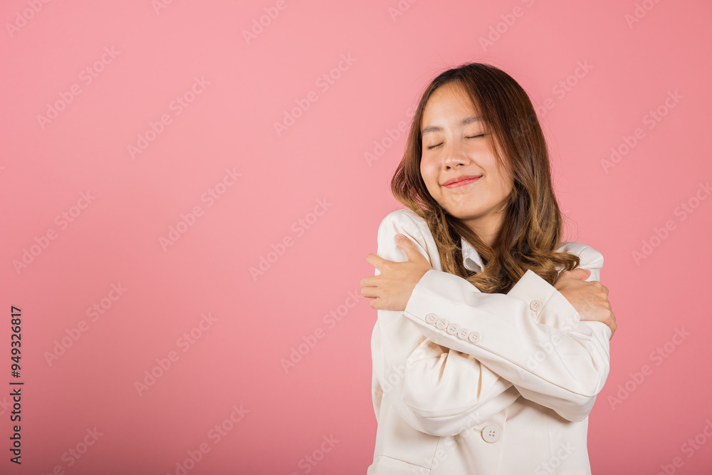 Happy beautiful young smiling Asian businesswoman hugging herself remember moment studio short isolated on pink background, Self care and self esteem concept, Lifestyle female love yourself carefree Happy beautiful young smiling Asian businesswoman hugging herself remember moment studio short isolated on pink background, Self care and self esteem concept, Lifestyle female love yourself carefree