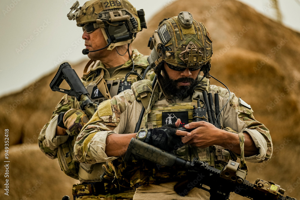 Fototapeta premium A group of military men in combat gear patrol in the middle of a desert and tropical jungle. Soldiers in full combat gear in dry weather conditions assemble and march on a mission.