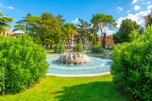 Fototapeta Naklejka Na Ścianę i Meble -  The Fountain of the Alps water feature located in the park area of the Piazza Bra, the central square in the city of Verona, Italy.