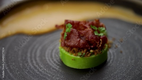 Extreme close-up view of spicy tuna poke stuffed avocados made by a professional chef in restaurant photo