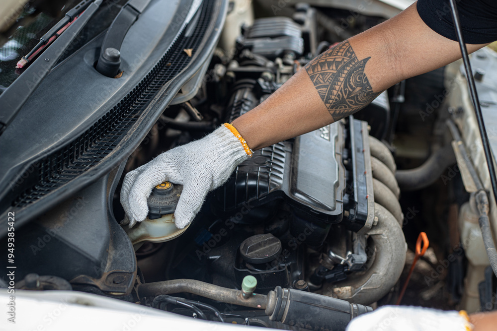 A person is working on a car engine A person is working on a car engine