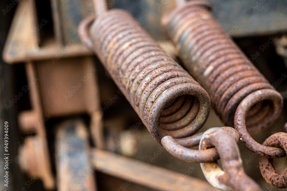 A rusty spring with a red and black design. A rusty spring with a red and black design.