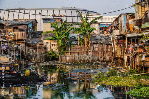 view of poor residential houses on the outskirts of the city with buildings in the background with the sky as copy space, slum dwellings on the banks of the river.