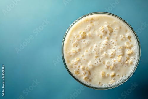 Close-up of Oatmeal in a Glass Bowl on Blue Background.