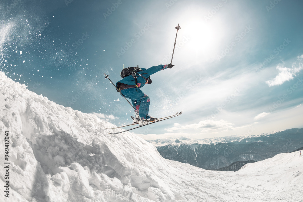 Fast and professional skier jumps at big speed from snowdrift high in mountains Fast and professional skier jumps at big speed from snowdrift high in mountains