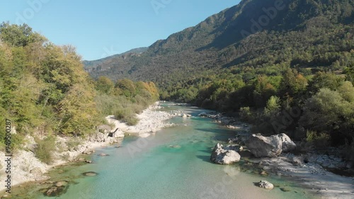 Soca river Slovenia aerial, drone flying forward above clear water on sunny summer day photo