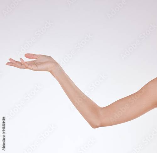 Hand, soft and skincare in studio, arm and shine with treatment in space, smooth and clean with routine. White background, reaching out and person with results of dermatology, cosmetics and mockup