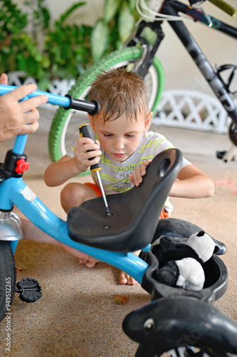 Kid boy repairing bicycle