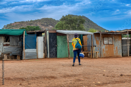 Obraz na płótnie african woman worker going to work in the morning in the shanty town , south afr