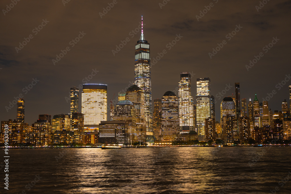 Obraz premium Night in The NYC city, USA, United States. Night day with iconic buildings. New York City NYC Manhattan Downtown Skyline, viewed from Jersey City, USA.