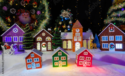 Wallpaper Mural Three small colorful houses against the background of Christmas trees and large Christmas houses Torontodigital.ca
