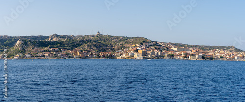 Panoramic view of La Maddalena village in the namesake archipelago, in Sardinia, Italy, seen from the sea, surrounded by nature. A famous tourist destination with colorful houses and nature reserve photo