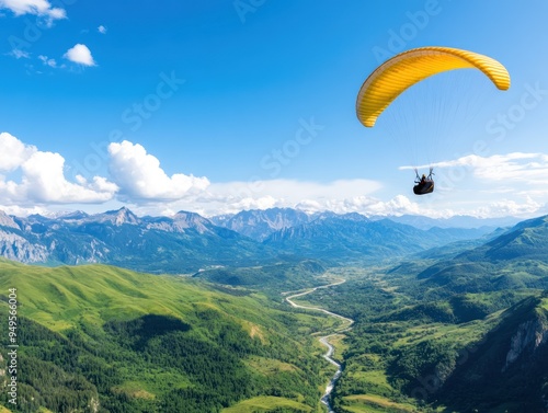 A paraglider soaring over a scenic valley, with mountains and rivers below