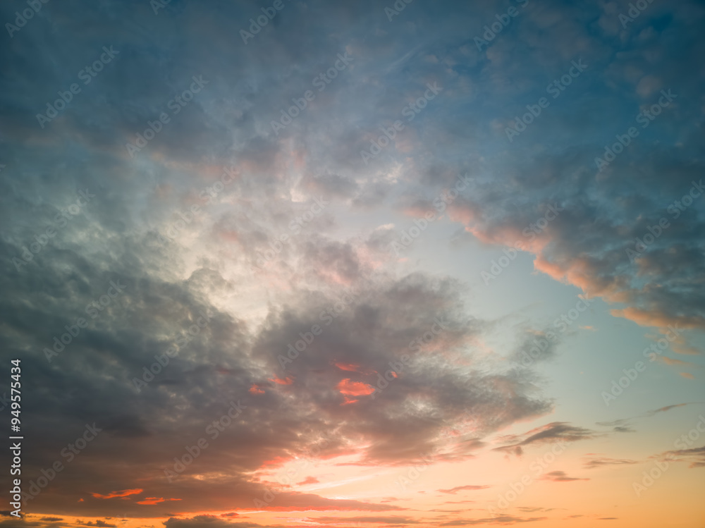 Fototapeta premium The rays of the sun breaking through the dramatic clouds in the evening or in the morning in the sunset or sunrise sky.