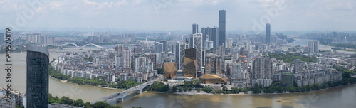 Panoramic, dynamic urban view of Liuzhou, Guangxi, China, featuring a sprawling cityscape with skyscrapers and a network of bridges spanning the wide Liujiang River. Panoramic of a Chinese metropolis. photo