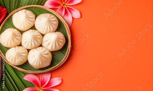 Kaju Modak indian traditional sweet dish on orange background with copy space. Banner for Hindu festival Ganesh Chaturthi, Diwali, Raksha Bandhan. photo