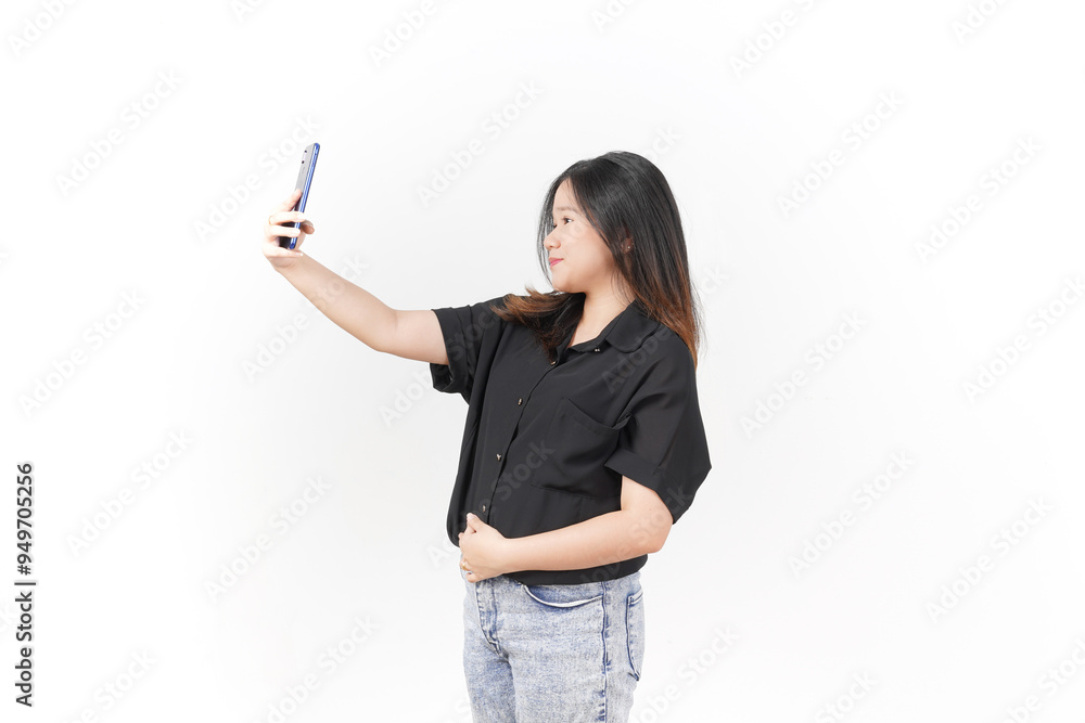 Young Asian woman taking selfie using smartphone wearing Black t-shirt and jeans isolated on white background Young Asian woman taking selfie using smartphone wearing Black t-shirt and jeans isolated on white background