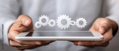 Businessman holding a tablet with gears and cogs