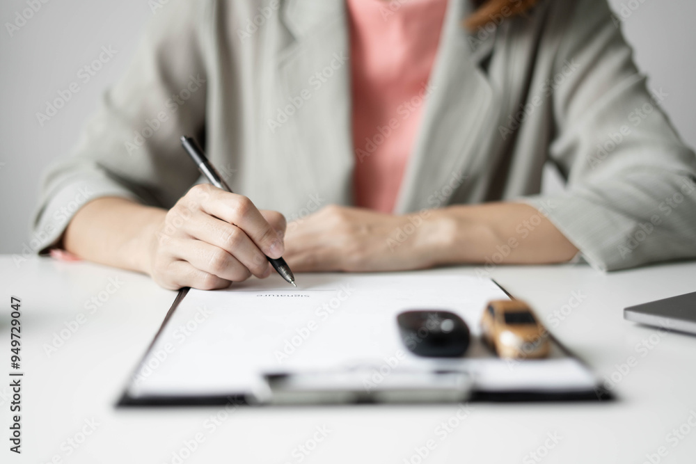 Naklejka premium Car dealer businesswoman signing car insurance document or lease paper. Car insurance, loans and Car rentals concept
