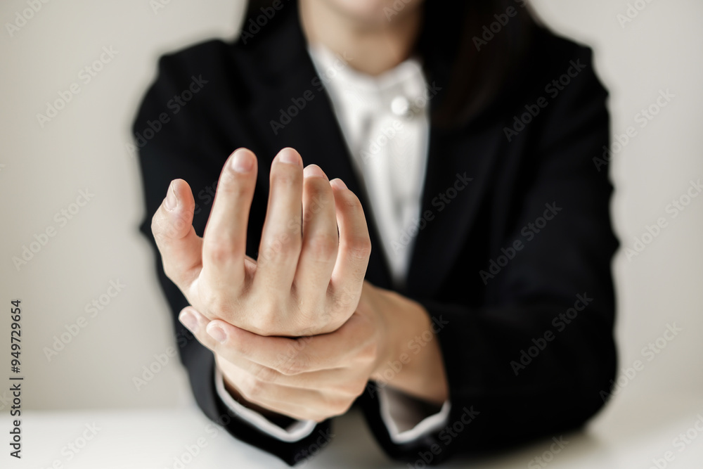 Fototapeta premium Woman hand with wrist pain numbness and pain in the palm of the hand has pain and tingling in the nerve endings This is a side effect of sitting and working for a long time on a laptop at the office