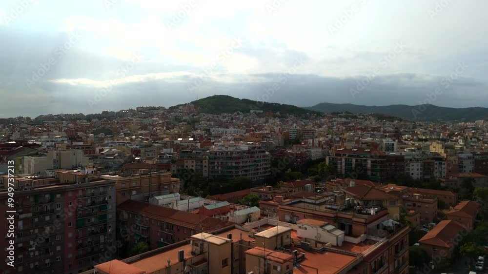 Drone flies towards Barcelona hills at sunset Drone flies towards Barcelona hills at sunset